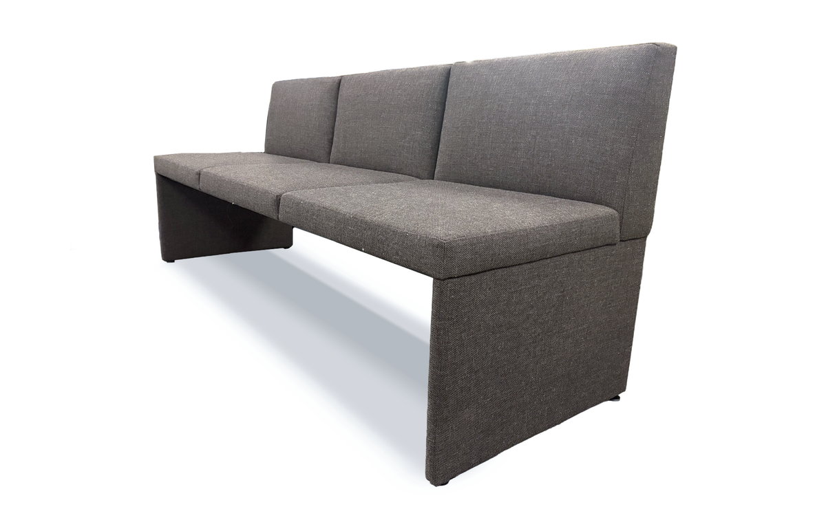 Long bench with upholster padded back and seater on a white background