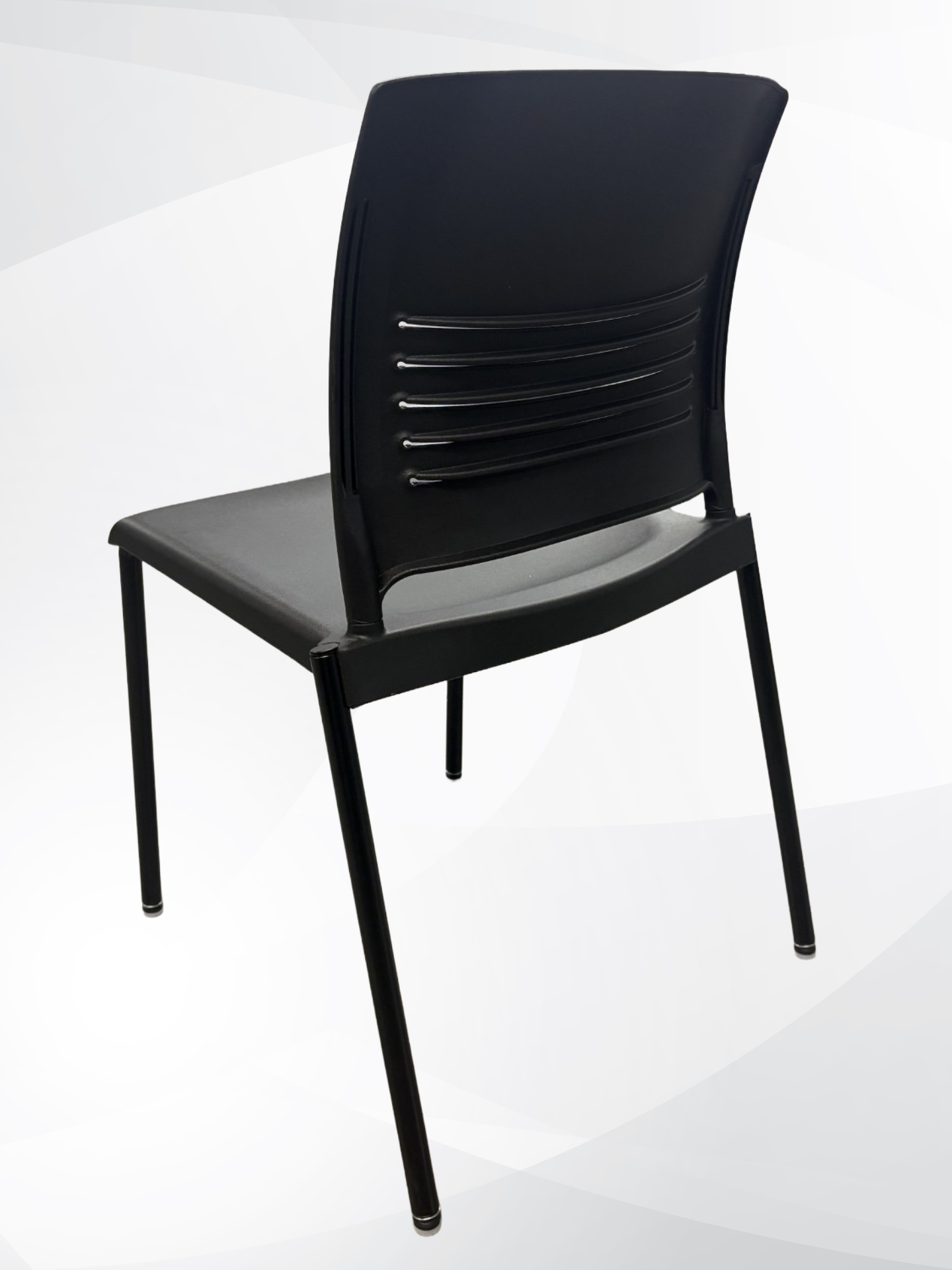 A black plastic dining chair with a curved backrest, horizontal support slats, and four slim legs, shown from a three-quarters angle on a light gray background.
