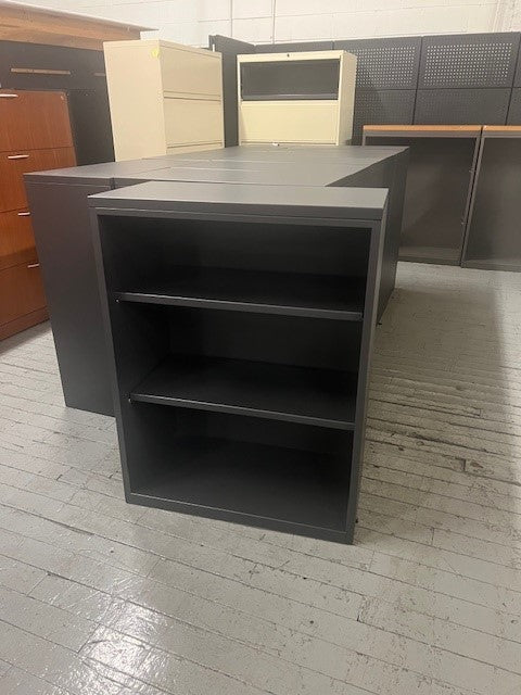 A black three tier bookcase.