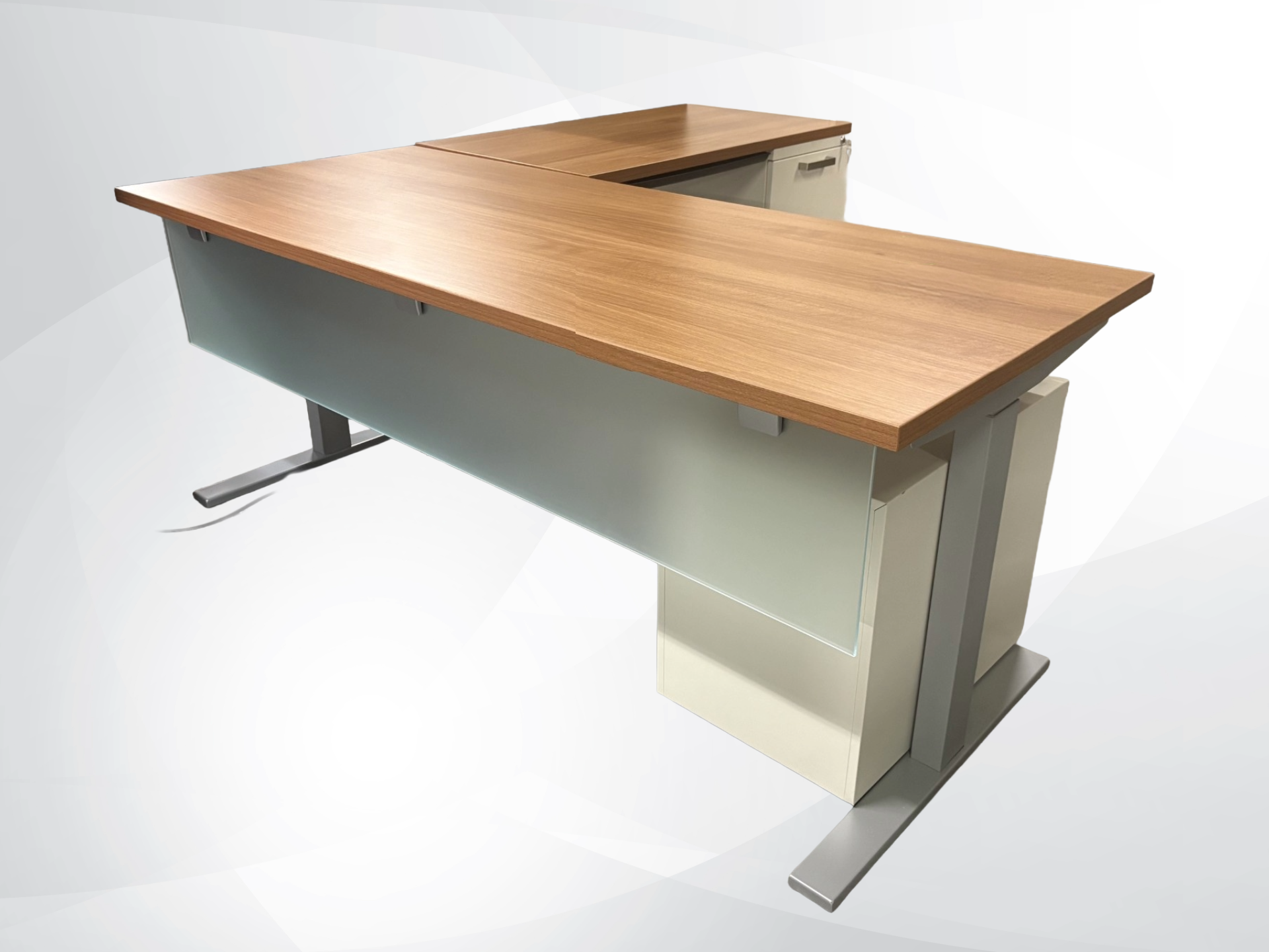 An L-shaped office desk with a light brown wood-grain top, a frosted light gray front panel, and a cream-colored base with silver metal legs, shown on a light gray background.