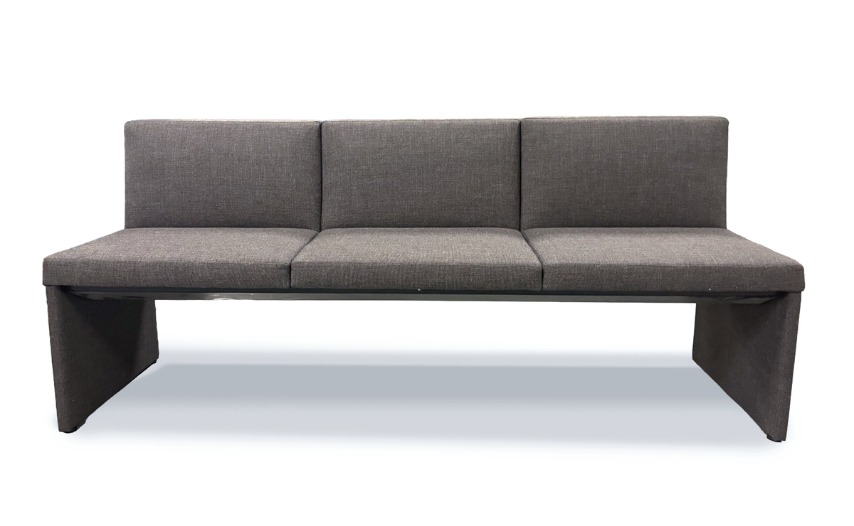 Long bench with upholster padded back and seater on a white background 