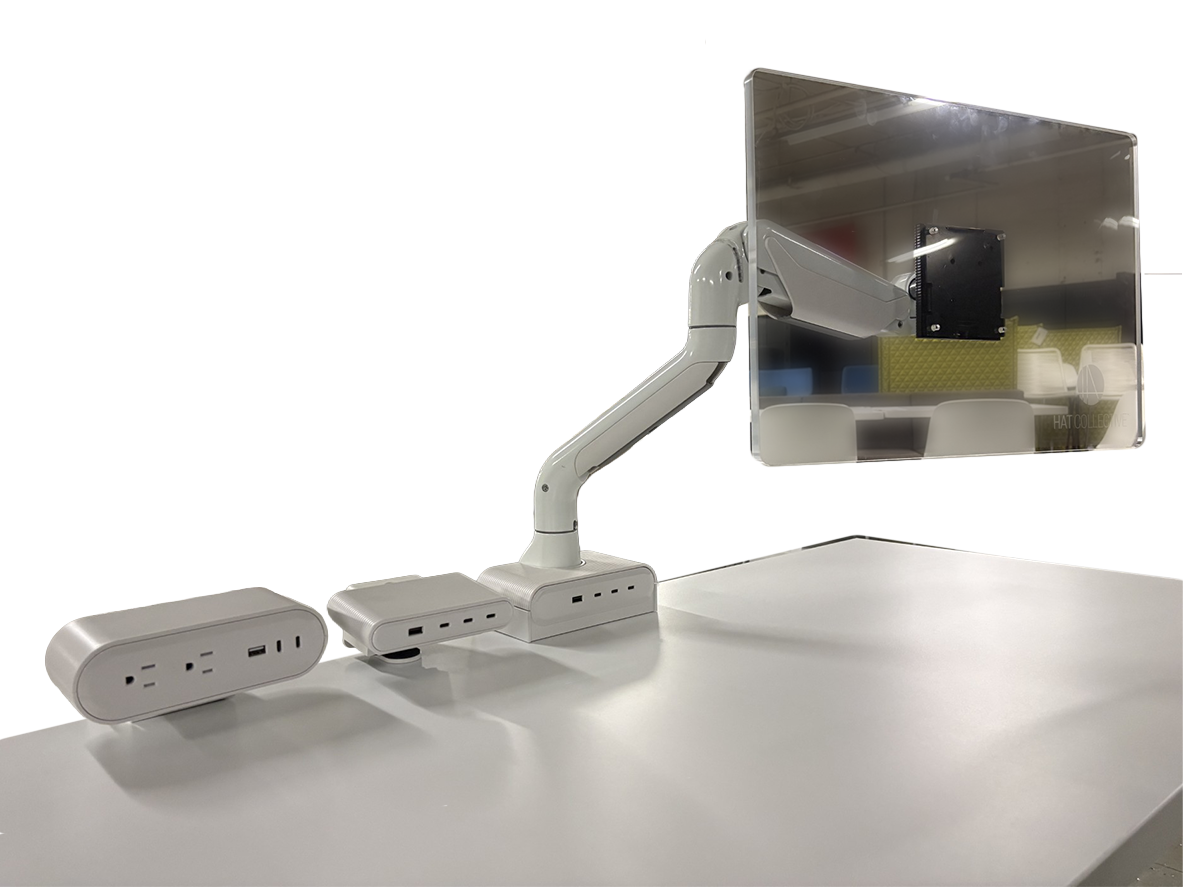 Monitor arm standing on desk with power modules on white background