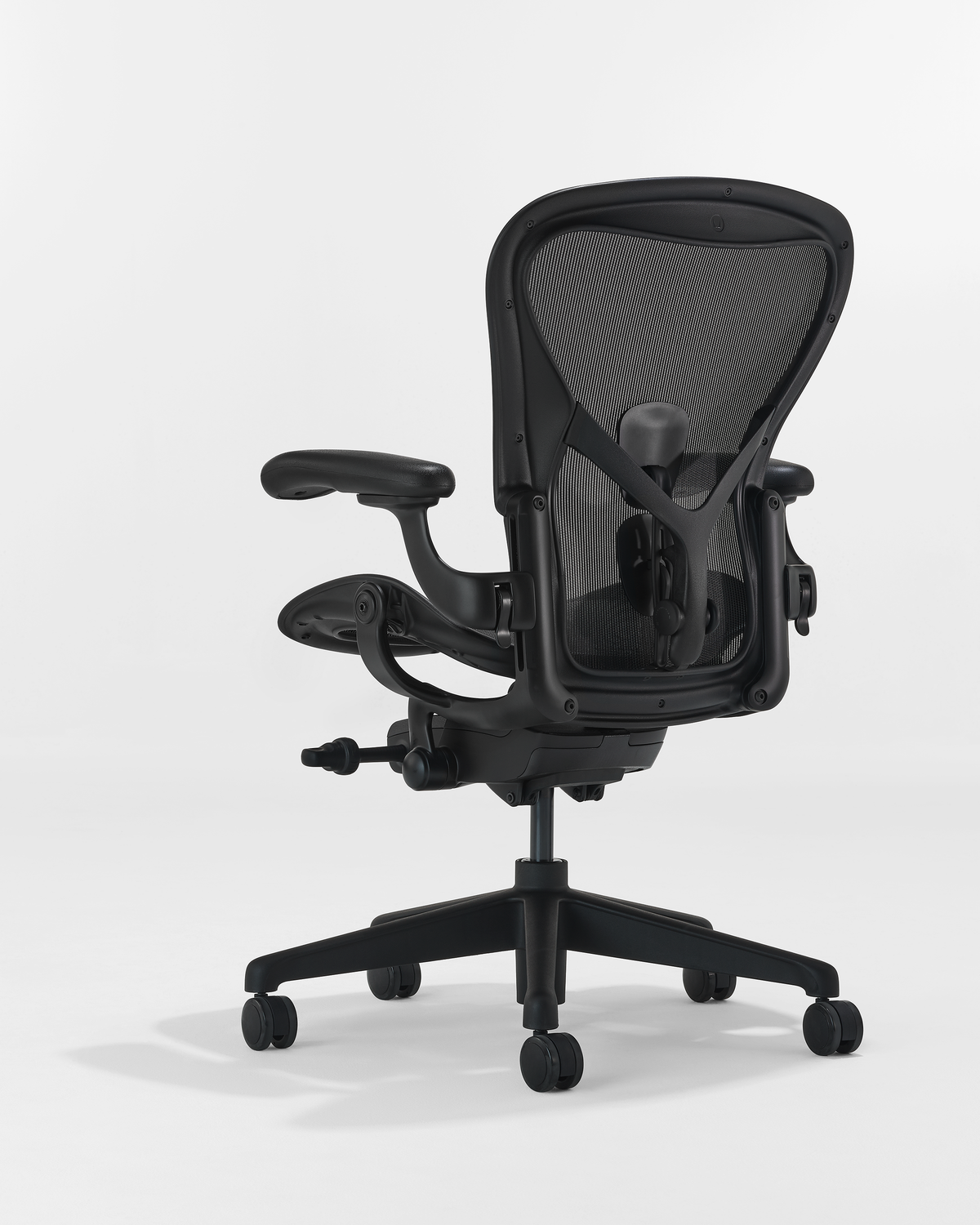 Herman Miller Black Aeron ergonomic office chair with breathable mesh back, adjustable arms, and lumbar support back view 