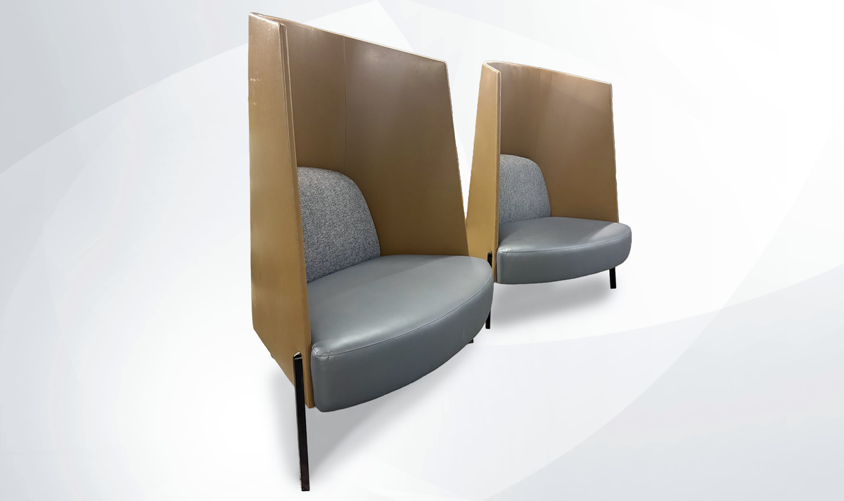 two high back lounge chairs brown and gray colors on soft gray background side view