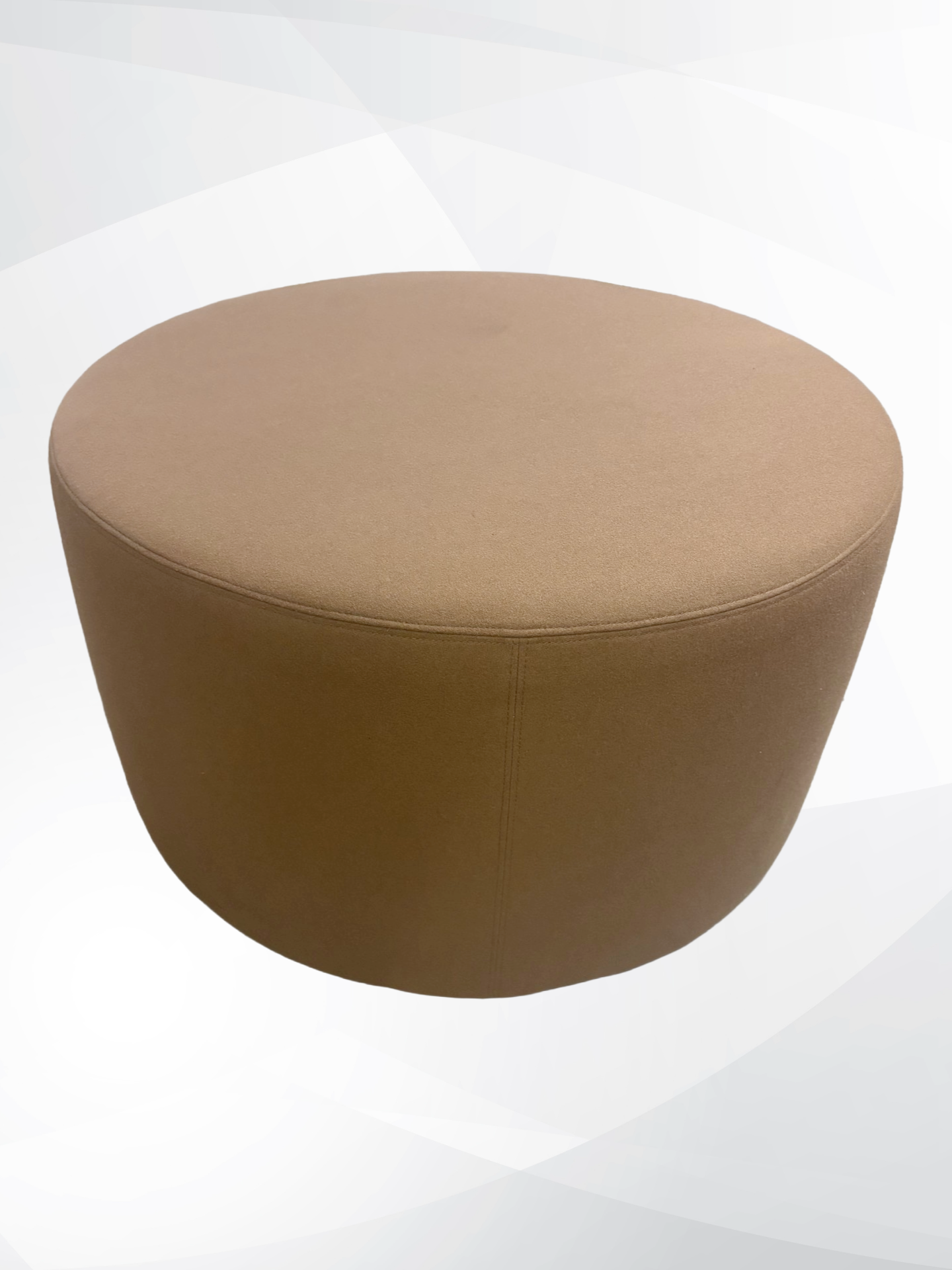 A round upholstered ottoman stool in a warm taupe-brown fabric, shown from a high angle against a light gray and white abstract background.