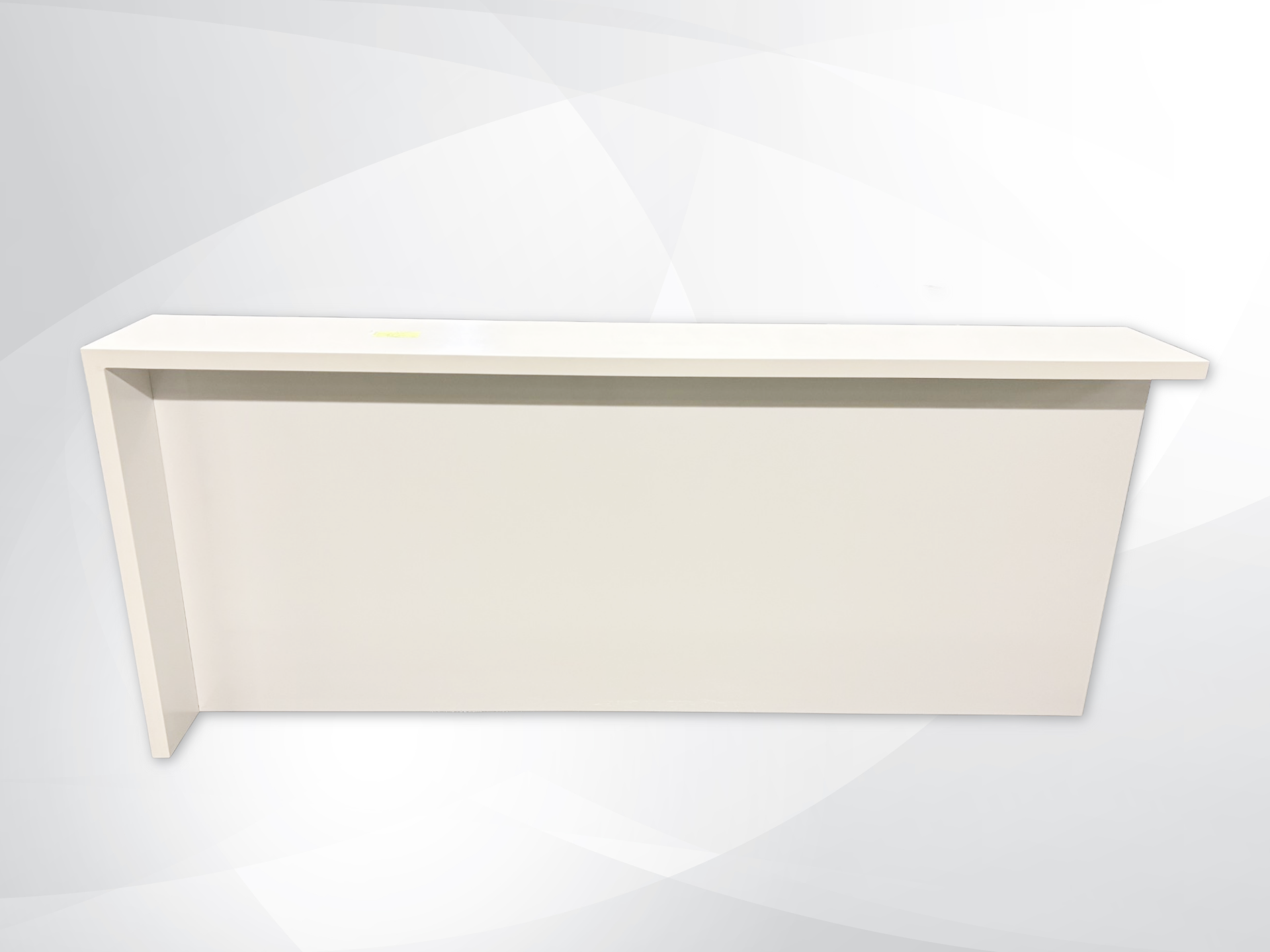 A modern, minimalist cream-colored wall-mounted shelf or console table with a clean, geometric L-shaped design, shown against a light gray and white abstract background.